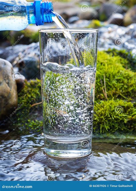 Water Pouring Into A Glass From Bottle Stock Photo Image Of Plastic