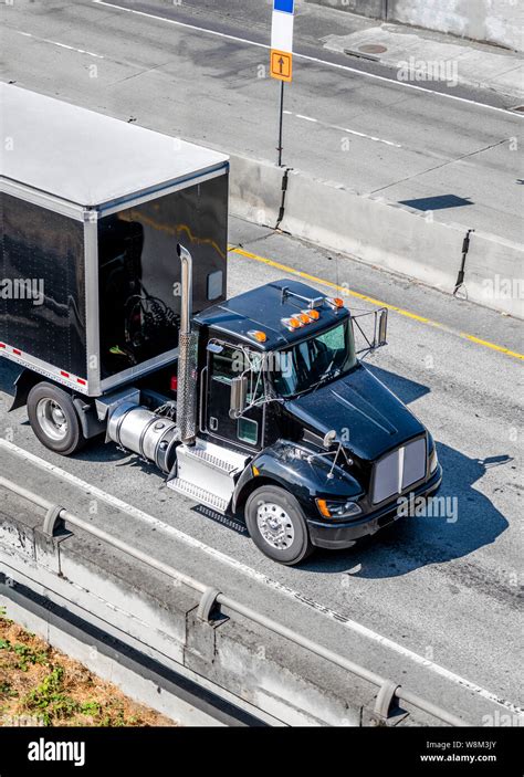 Shiny Black professional industrial grade big rig day cab semi truck for local deliveries ...