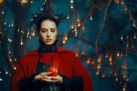 Evil Queen Holding A Red Poisonous Apple As Bait Stock Image Image Of