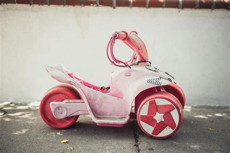 Children Pink Ride-on Toy on Road · Free Stock Photo