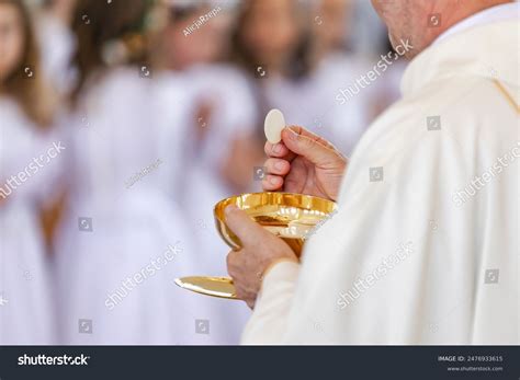 catholic priest serving jesus eucharist  stock photo