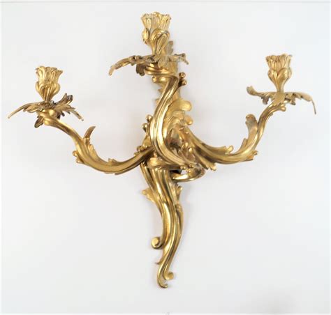 Paire d appliques de style Louis XV en bronze doré à 3 bras de lumière