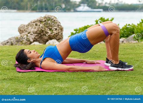 Fitness Woman Doing Glute Bridge Exercise With Resistance Band