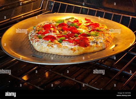 A Frozen Pizza Cooking In An Oven Stock Photo Alamy