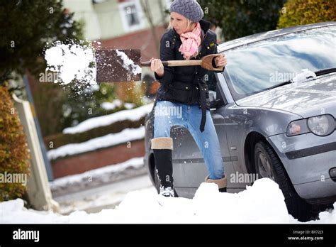 Woman Digging Out Car From Snow Stock Photo Alamy