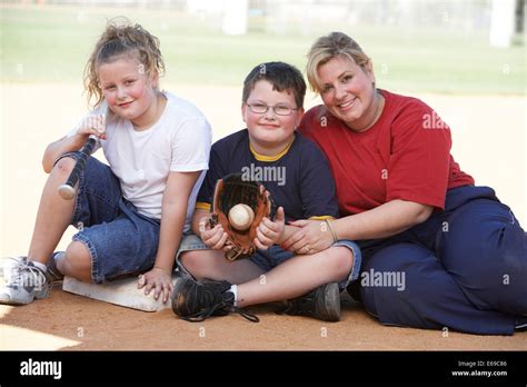 Mother and children smiling outdoors Stock Photo - Alamy