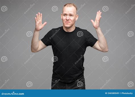 Staged Photo Of Disturbed Man In Black Standing At Studio Stock Image