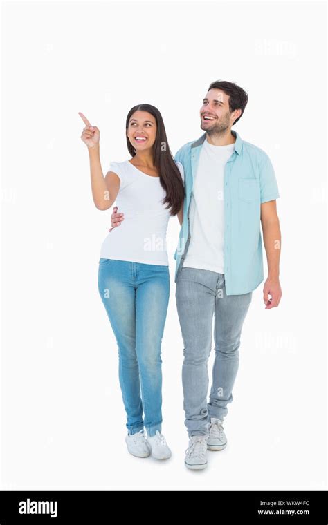 Happy casual couple walking together on white background Stock Photo ...