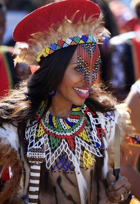 a woman wearing an elaborate headdress and holding a knife in her hand ...