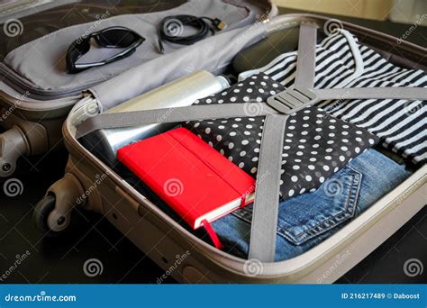 Open Suitcase Full Of Clothes Isolated On Black Background Stock Image