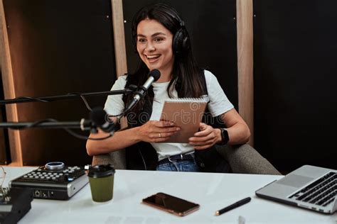 portait  attractive young female radio host holding  script