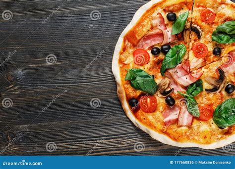 Top View Of Italian Pizza With Mushrooms Basil Tomato Olives And