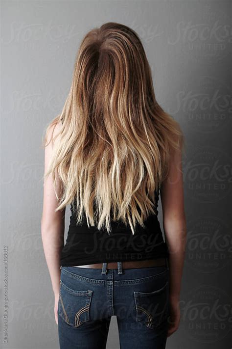 Backside Of Teenager With Long Hair Wearing Jeans And Black Tank Top By