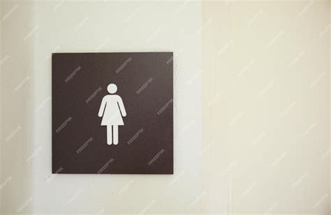 Premium Photo | A bathroom sign for a woman with a white female symbol ...