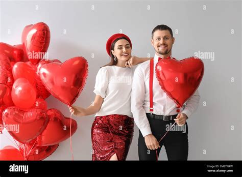 Happy Couple In Love With Balloons On Grey Background Valentines Day