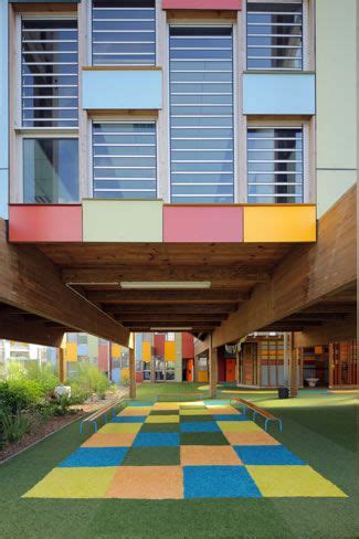 An Outdoor Area With Colorful Tiles On The Ground And Grass In Between