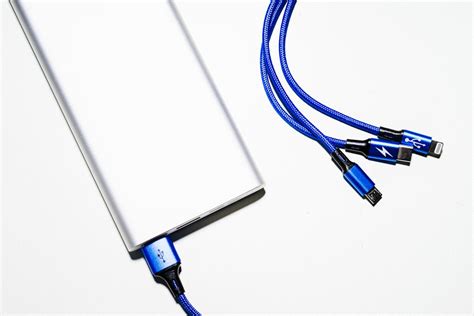 White Power Bank and Blue Coated Wires · Free Stock Photo