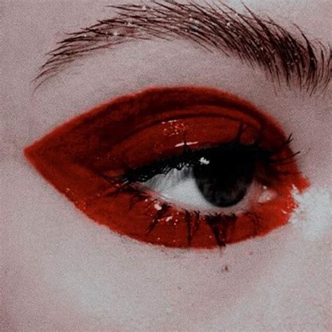 A Woman S Eye With Red And White Makeup