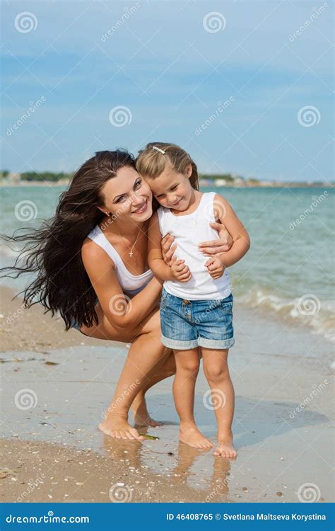 Happy Beautiful Mother And Daughter Enjoying Beach Time Stock Image