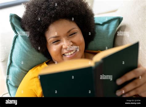 High Angle Close Up Smiling African American Mid Adult Woman Reading