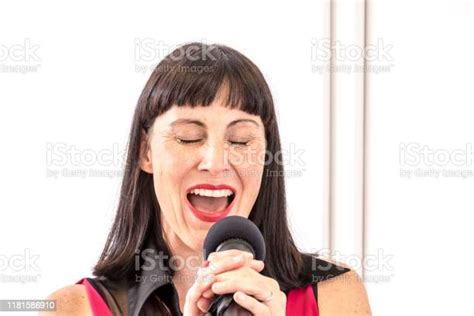 Enthusiastic Singer Woman Singing Into Microphone In The Recording