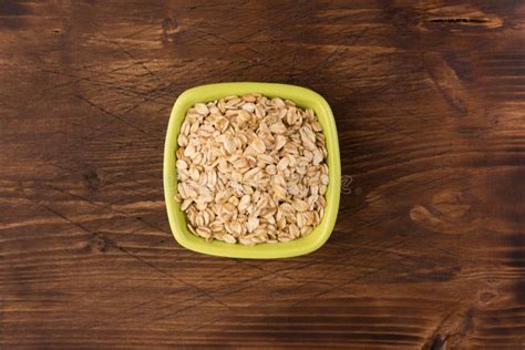 Rolled Oats Or Oat Flakes In Bowl On Wooden Background Stock Image