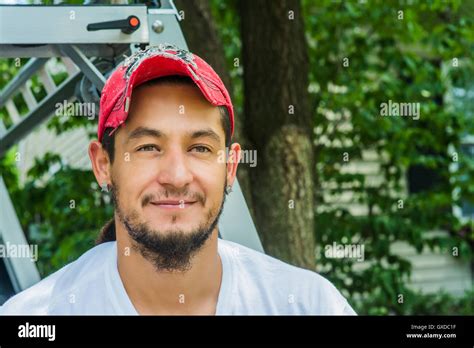 Portrait Of Man Wearing Baseball Cap Looking At Camera Smiling Stock