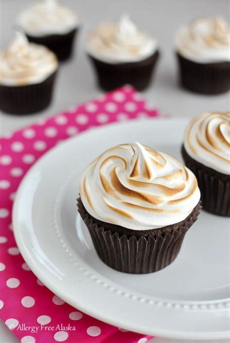 Three Cupcakes With White Frosting On A Plate