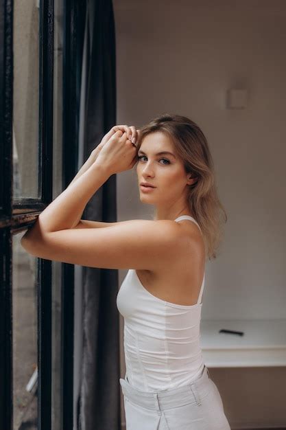 Premium Photo Beautiful Blonde Standing By The Window
