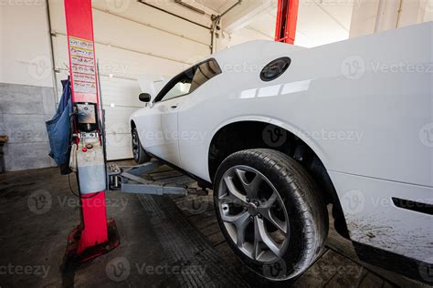 Muscle car with open hood at service repair station in lift. 16480713 Stock Photo at Vecteezy