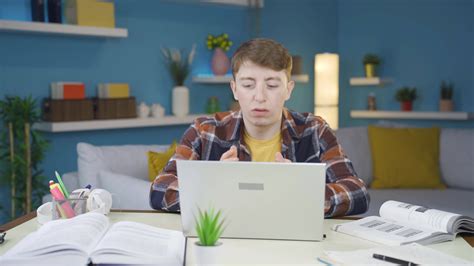 Frustrated student turns off his laptop and stops doing homework