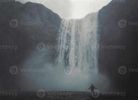 Person enjoys waterfall landscape photo 16562838 Stock Photo at Vecteezy