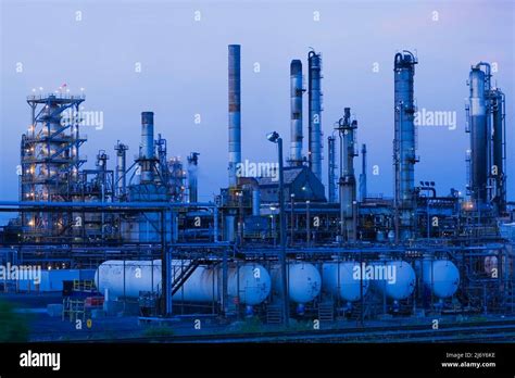 Oil And Gas Refinery With Storage Tanks And Towers At Dusk Montreal