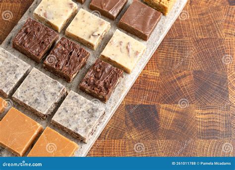 An Assortment Of Various Flavors Of Fudge On A Wood Butcher Block Stock