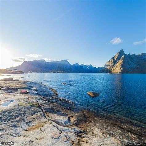 the sun shines on some mountains and water near a large body of water ...