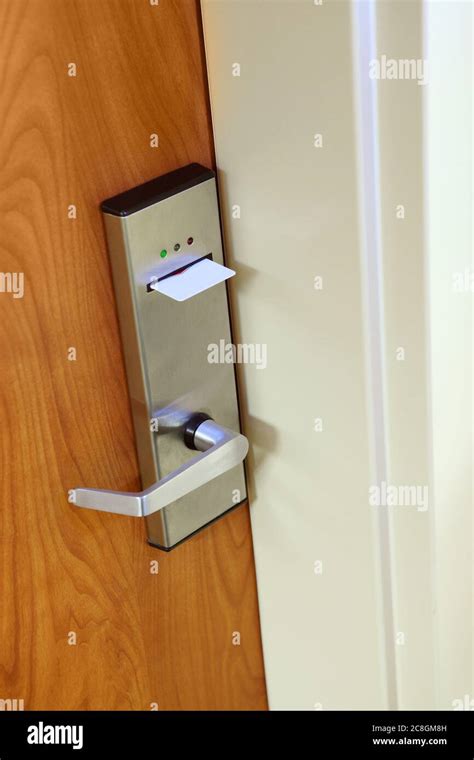 A modern key card door lock on a hotel room door, with a key card ...