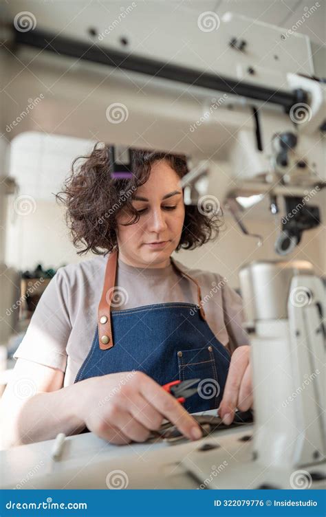 A Woman Tanner Sews A Leather Belt On A Sewing Machine Vertical Photo