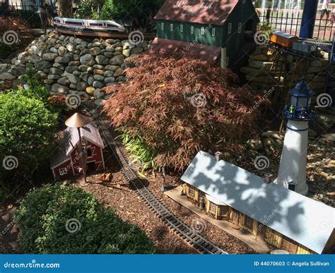 Outdoor Model Train Track With Train Station Lighthouse And Barn