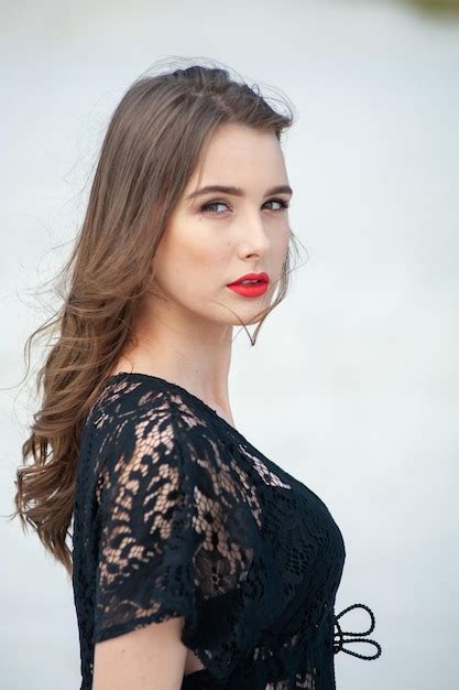 Premium Photo A Woman With Long Brown Hair And Red Lipstick Looks