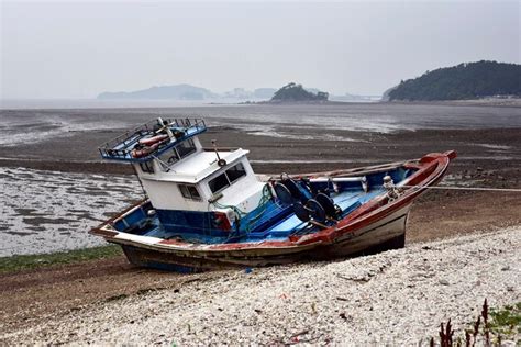 Premium Photo Boats Moored On Beach Against Clear Sky