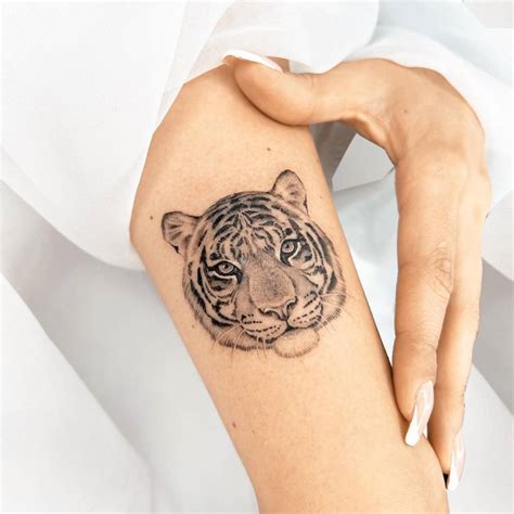 Micro-realistic tiger portrait tattoo located on the