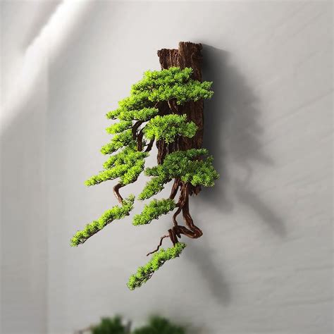 A Bonsai Tree Is Hanging On The Wall