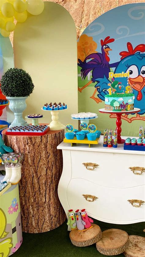 A Table Topped With Cake And Cupcakes Next To A Wall