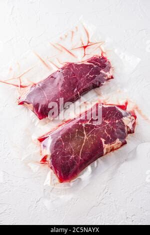 Ensemble de steak de bœuf emballé sous vide sur fond de table en