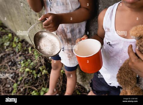 Cropped View Of Homeless African American Kids Holding Cup And Metal