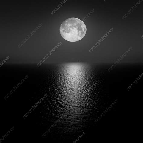 Full Moon setting over water horizon - Stock Image - C059/7653 - Science Photo Library