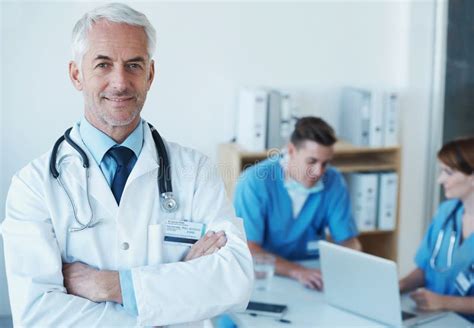 Smile Crossed Arms And Portrait Of Doctor In Meeting With Nurses For Medical Research In