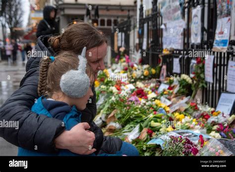 Une Personne En Deuil Embrasse Sa Fille Devant Les Hommages Floraux