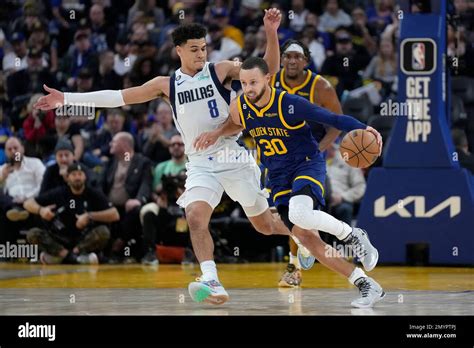 Golden State Warriors Guard Stephen Curry 30 Brings The Ball Up The Court Against Dallas