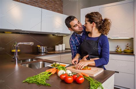 Couple In Kitchen Hugging And Cook High Quality People Images